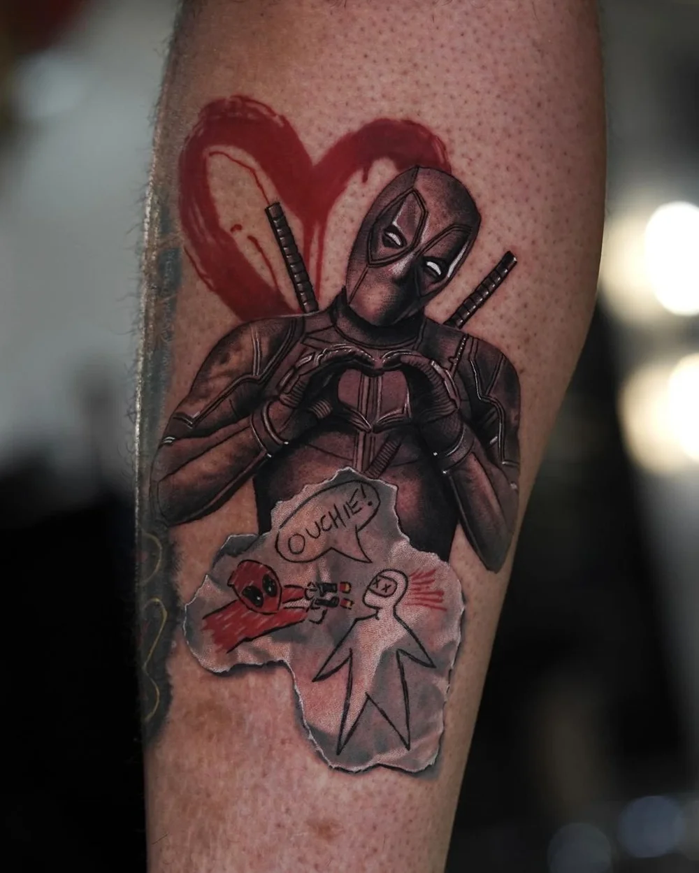 Color Deadpool tattoo making a heart-hands gesture by Pony Lawson